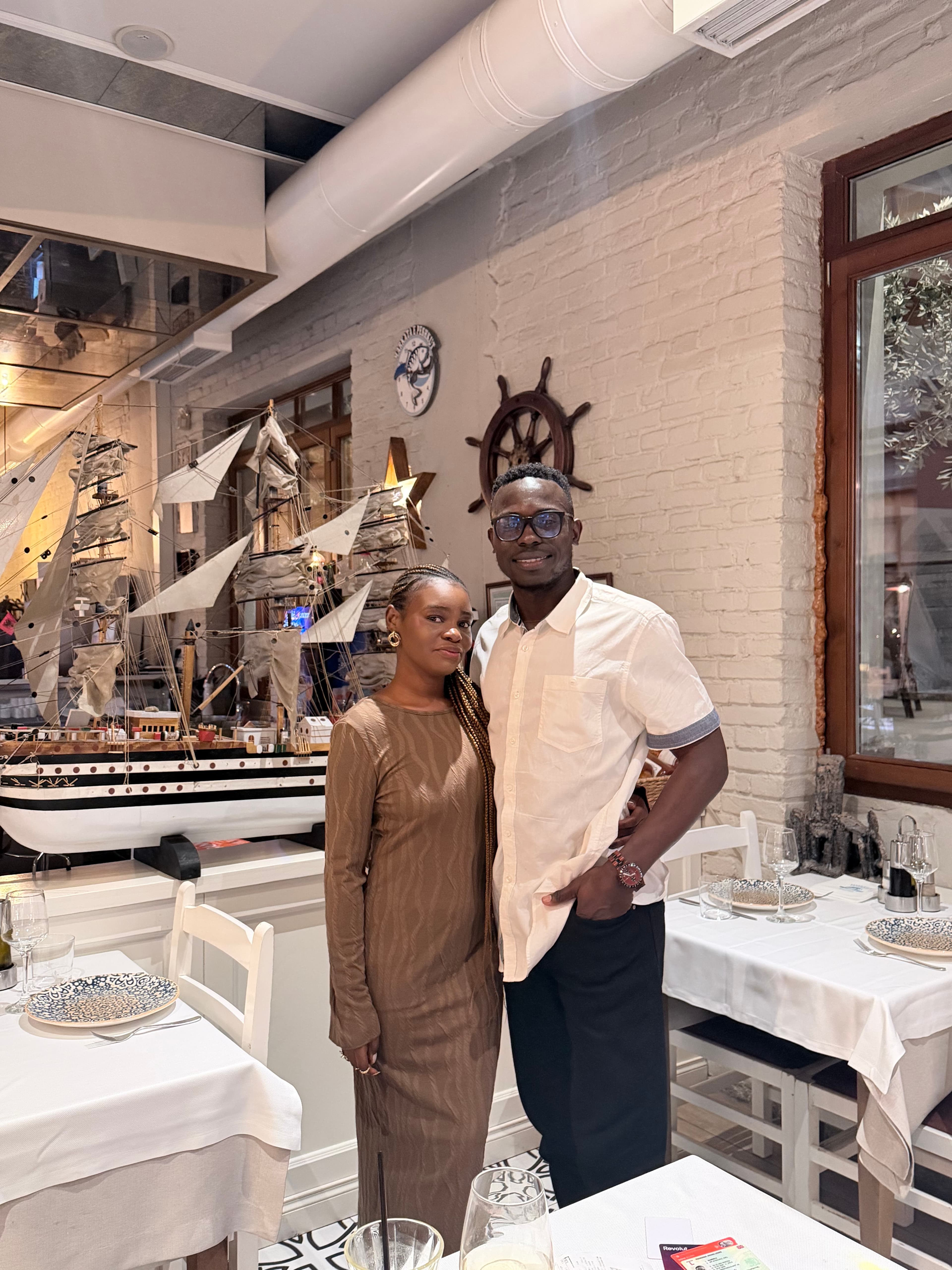 Ayo and Ola standing together during a dinner date