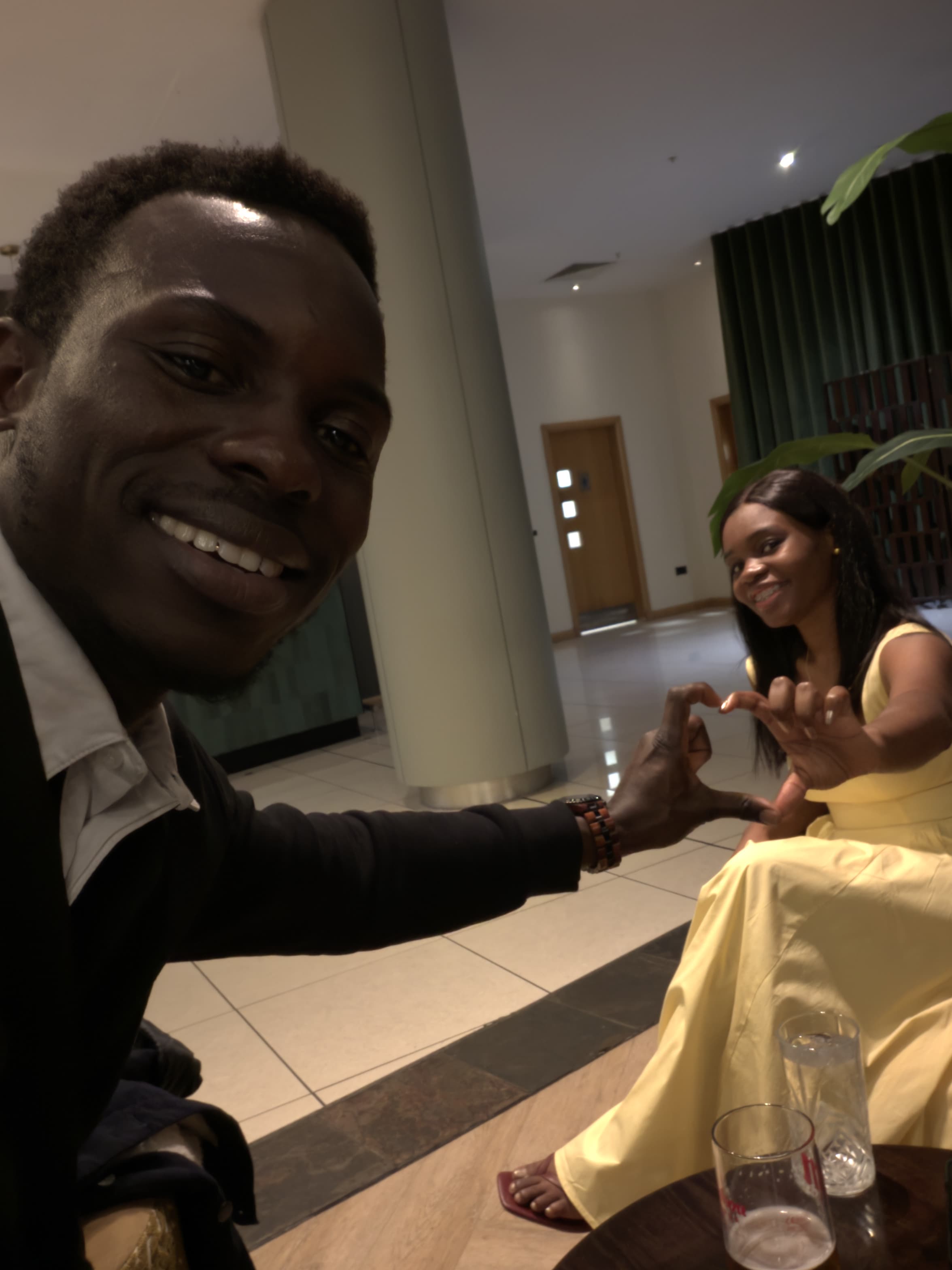 Ayo and Ola making heart shapes with their hands