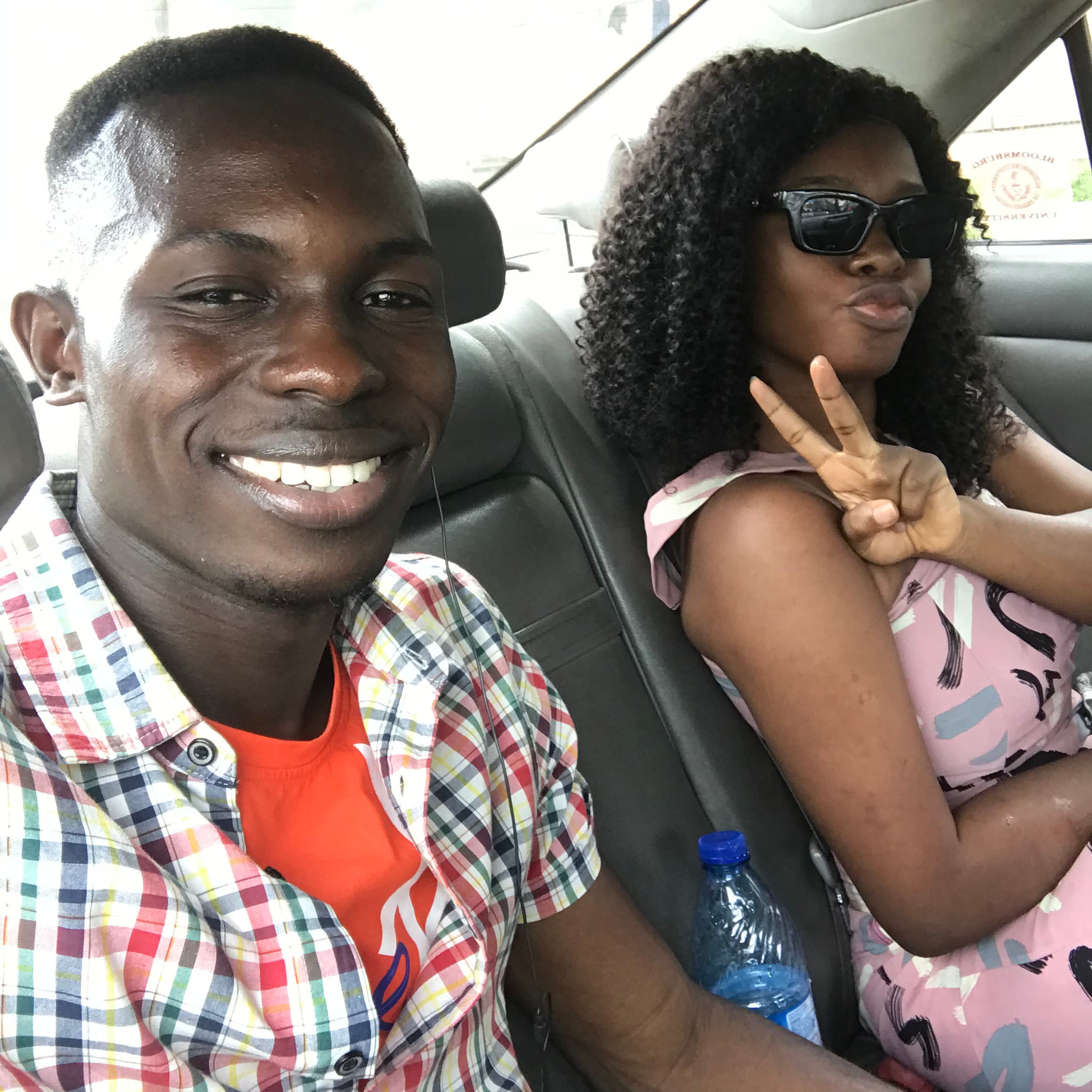 Ayo and Ola taking a playful selfie in the car